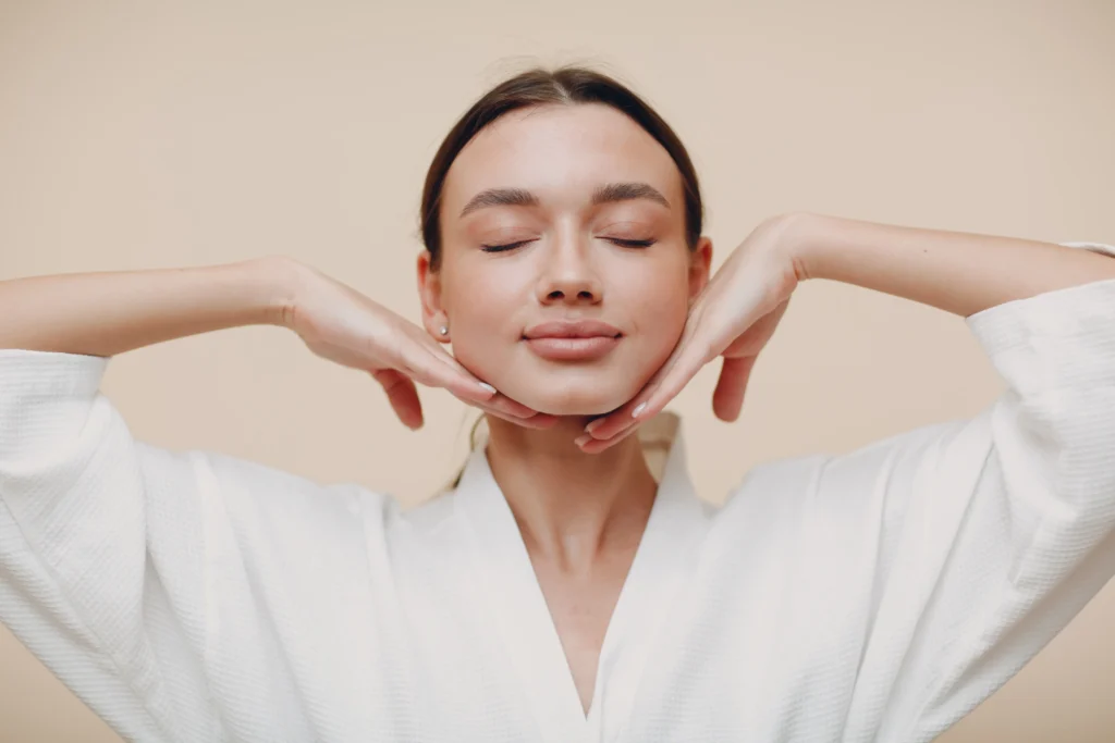 Woman practicing self-massage as part of acne skincare routine in Cranston, RI