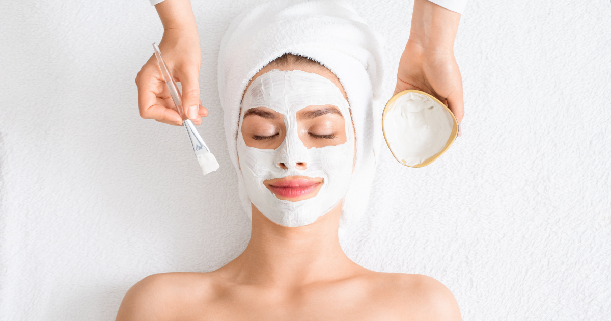 Woman enjoying a relaxing facial treatment with a mask in Cranston, RI spa